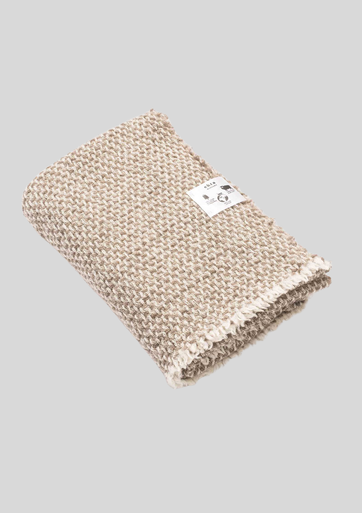 Textured pattern white and beige colored throw made out of responsible Finnish sheep wool. Manufactured in Finland.  