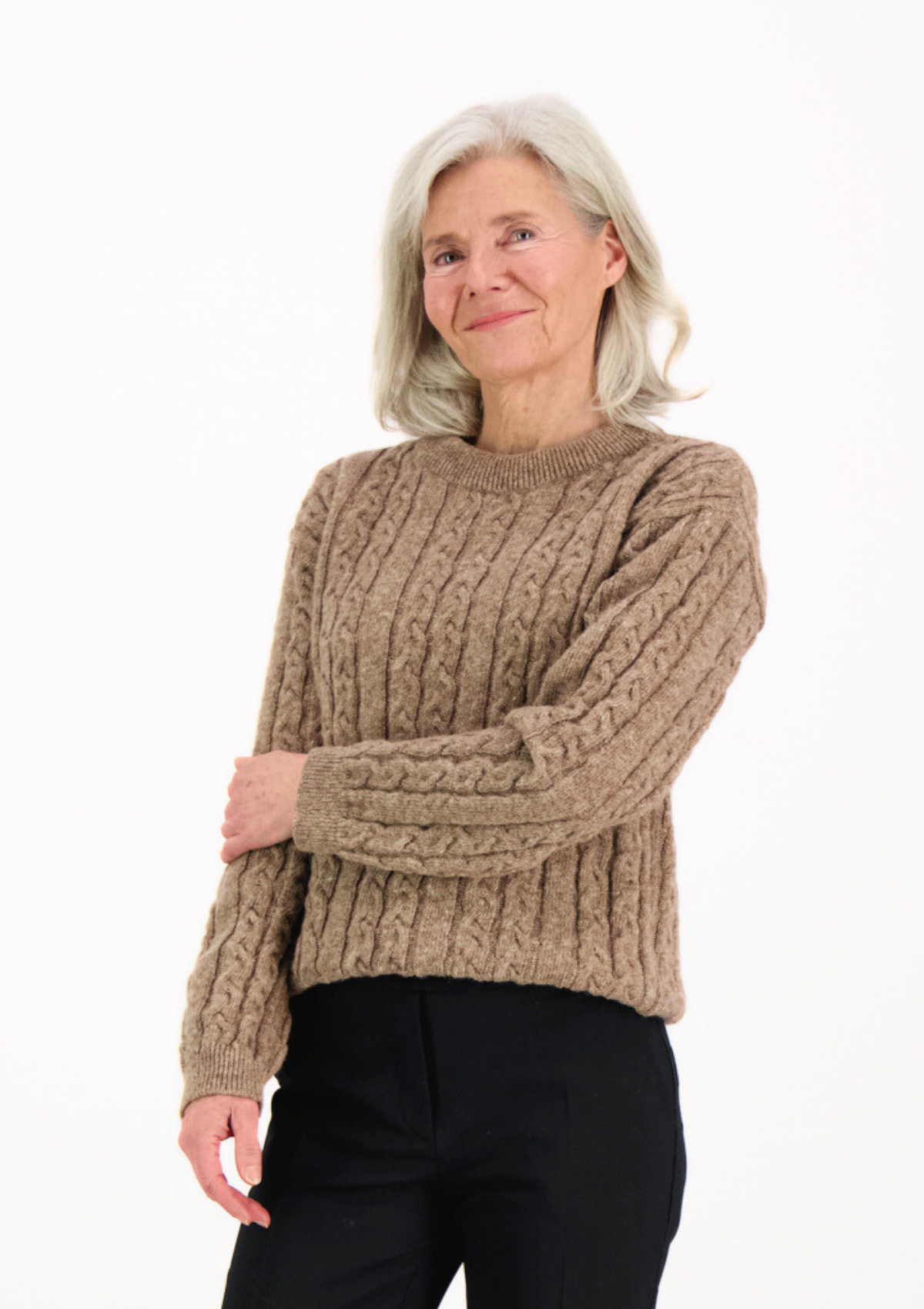 Soft and elegant cable knit in beige with o-neck. Made of responsible Finnish sheep wool in Finland. 