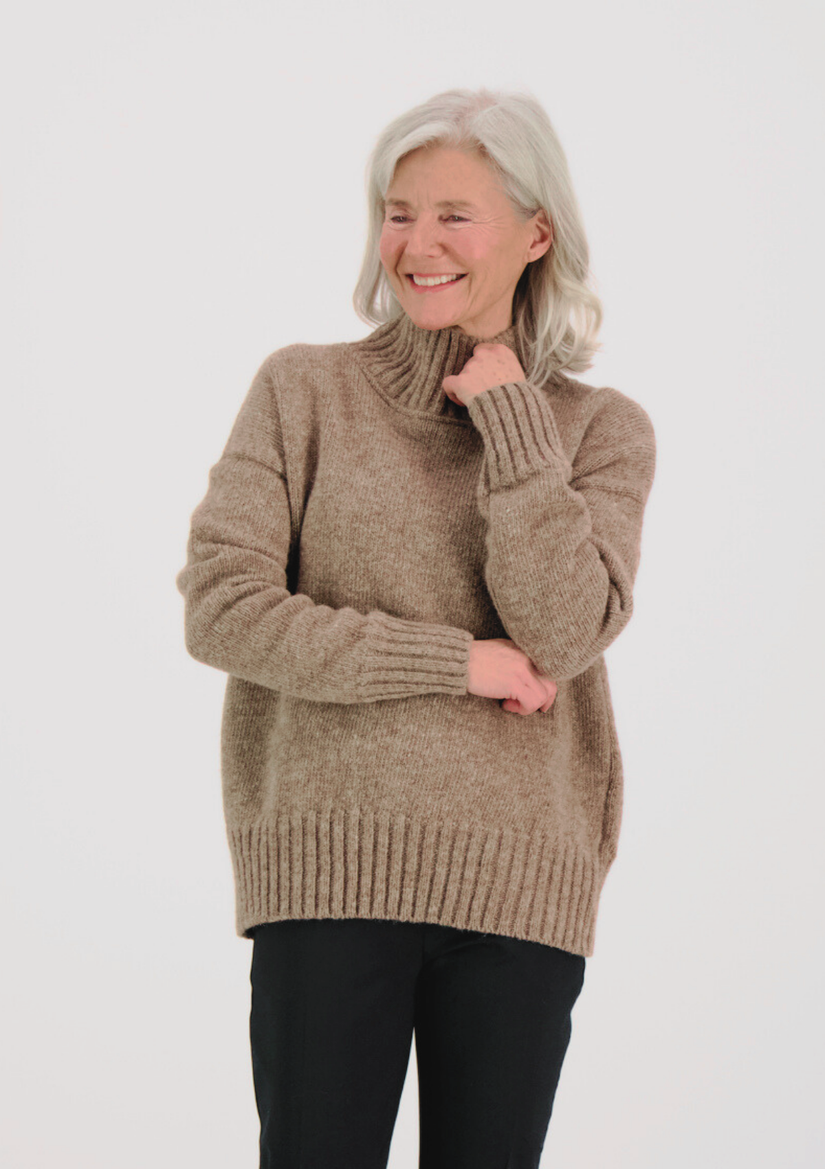 Beige responsible funnel-neck knit made out of Finnish sheep wool, manufactured in Finland.